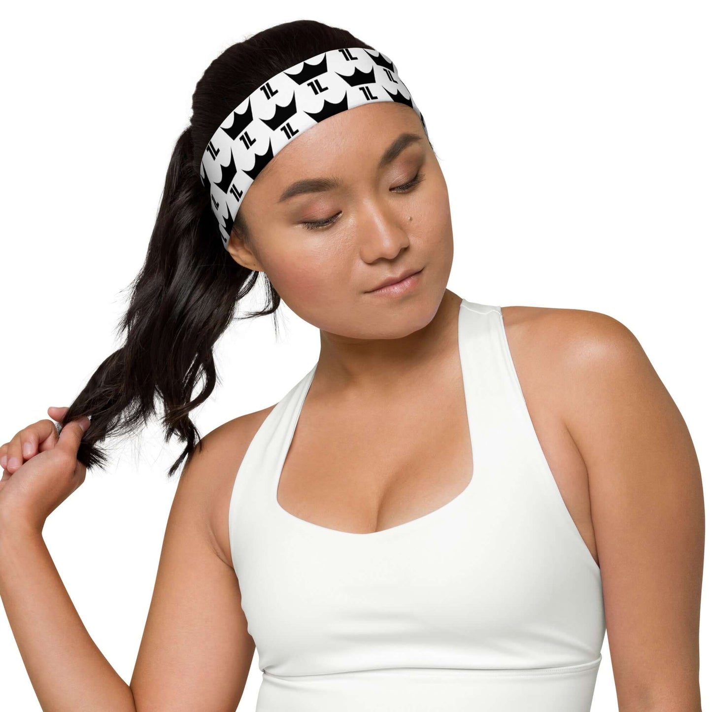 Woman wearing white workout headband with black 1L Logo pattern